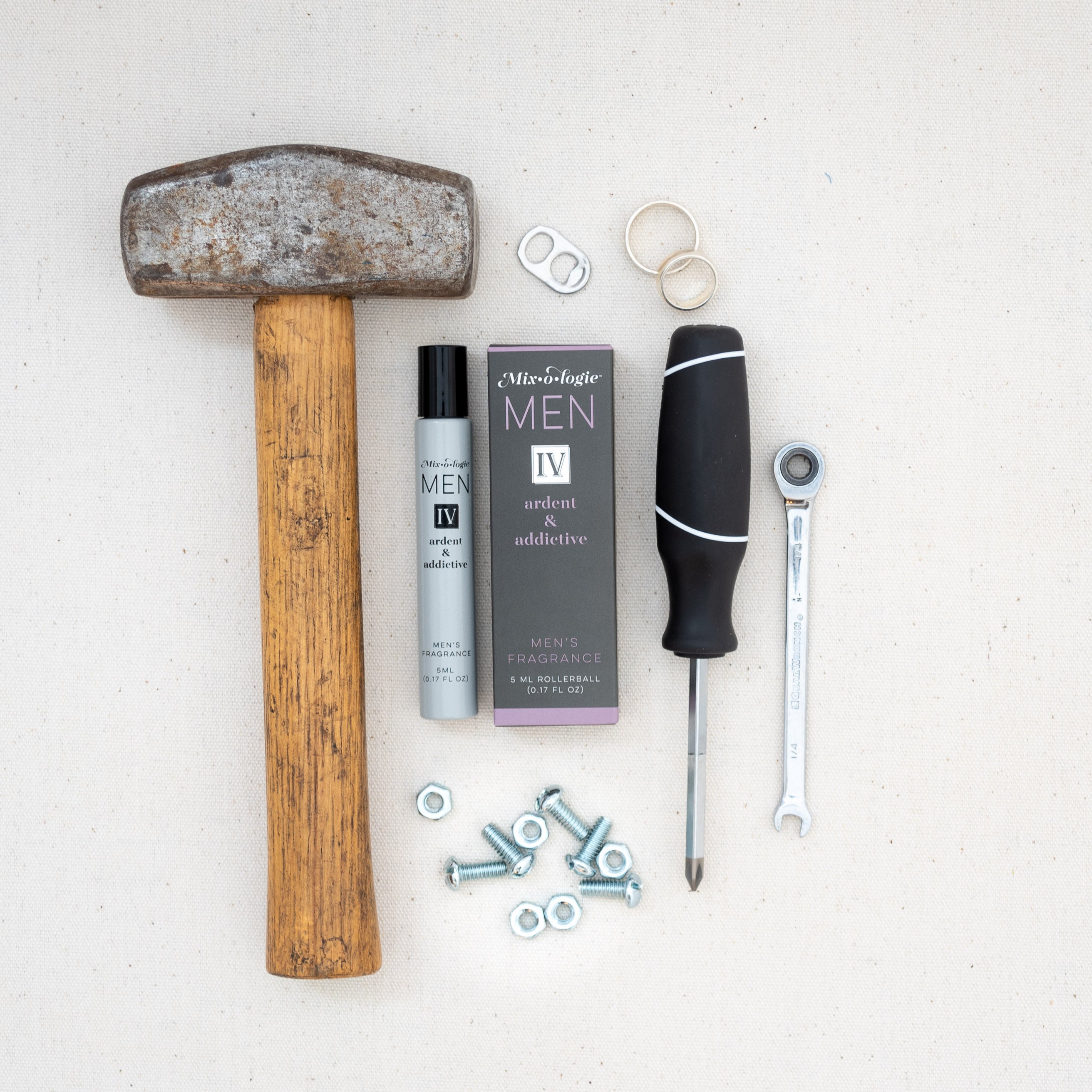 Mixologie rollerball scented with Men's IV (Ardent & Addictive) fragrance in 5 mL glass bottle displayed with tools.