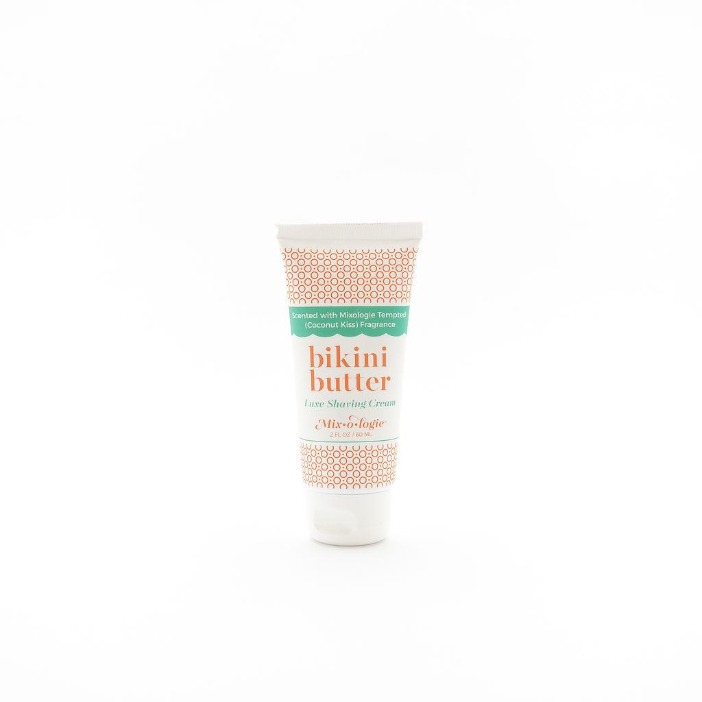 Luxe Shaving Cream Bikini Cutter scented with Mixologie Tempted (Coconut Kiss) Fragrance in a 2 fl oz or 60 mL white tube with orange circle pattern and white cap. Bikini Butter pictured with white background.