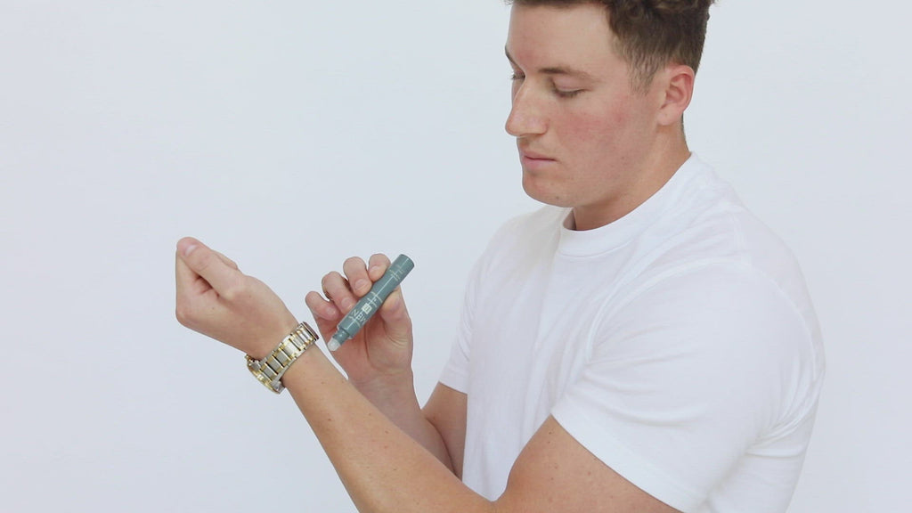 Mixologie rollerball scented with Men's II (Modern & Masculine) fragrance in 5 mL glass bottle being applied to model's wrist.