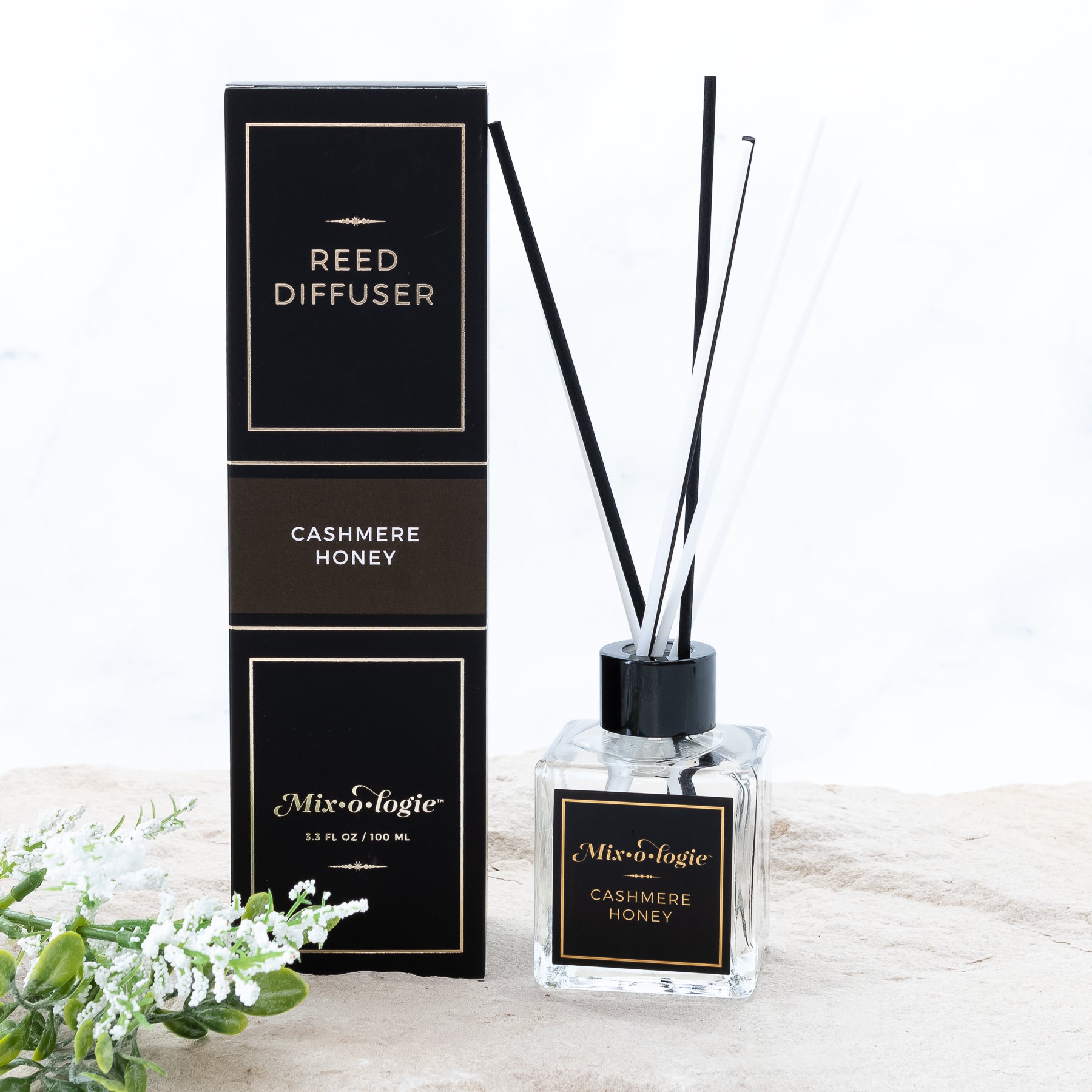 Reed diffuser scented with cashmere honey. 3.3 FL OZ glass bottle with 8 black and white reed diffuser sticks.