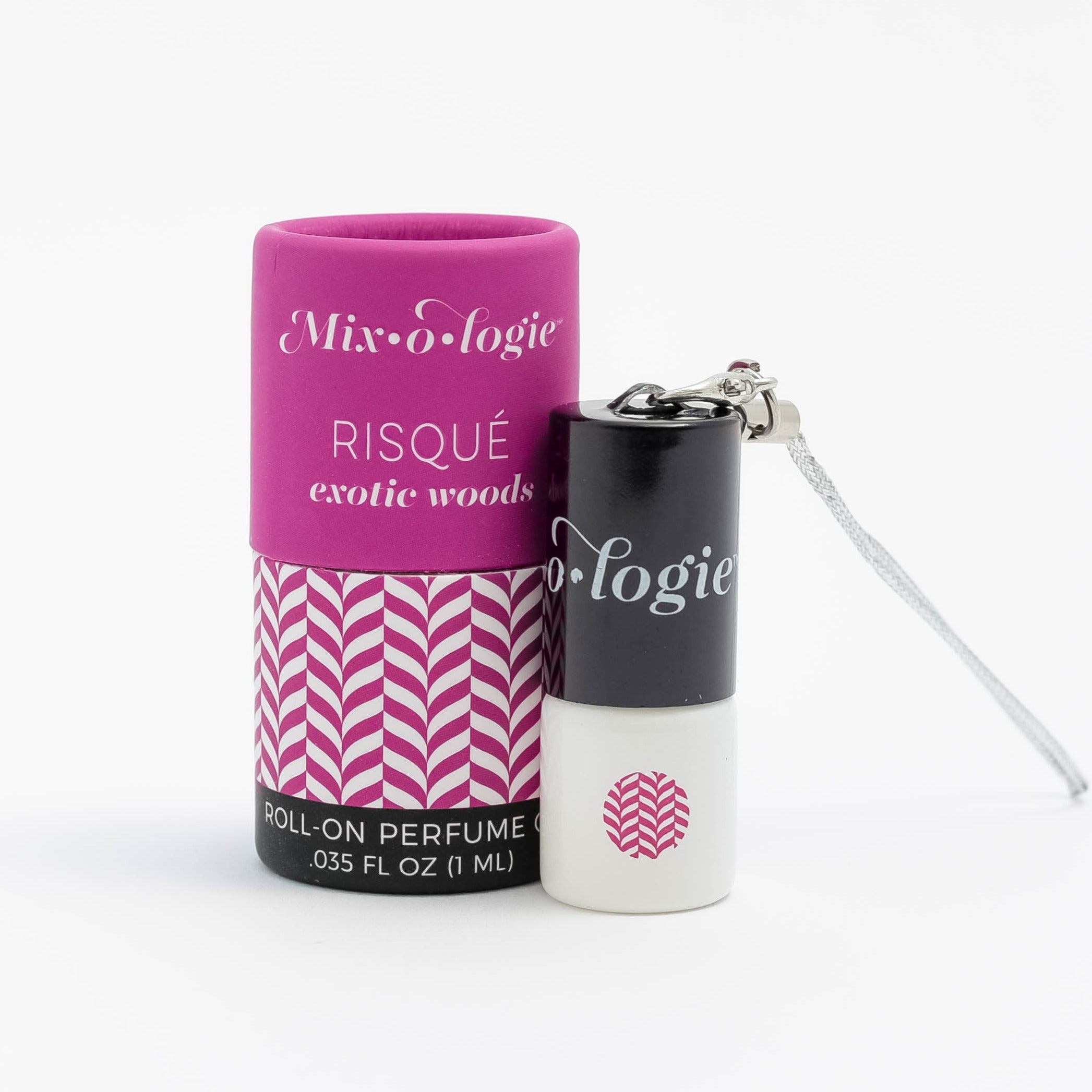 Mixologie's Risque (exotic woods) scented mini rollerball in 1 mL bottle with keychain lid. displayed with cylinder packaging.