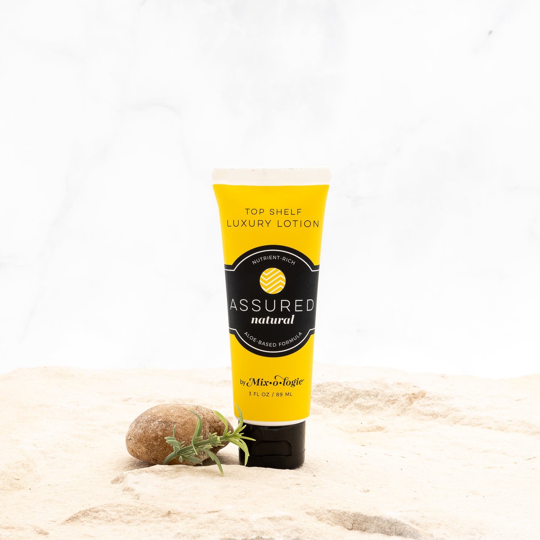 Mixologie's Top Shelf Luxury Lotion with aloe-based formula scented with Assured (natural) in 3 FL OZ plastic tube. 