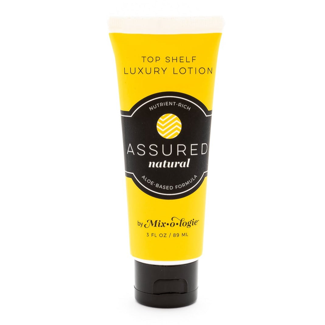 Mixologie's Top Shelf Luxury Lotion with aloe-based formula scented with Assured (natural) in 3 FL OZ plastic tube.
